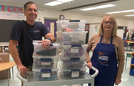 Volunteers standing with donations