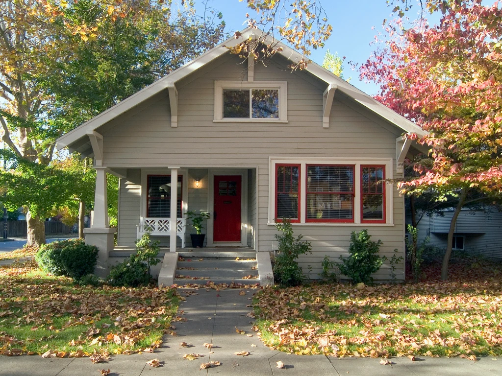 Exterior of Home with Red Door on a Fall Afternoon