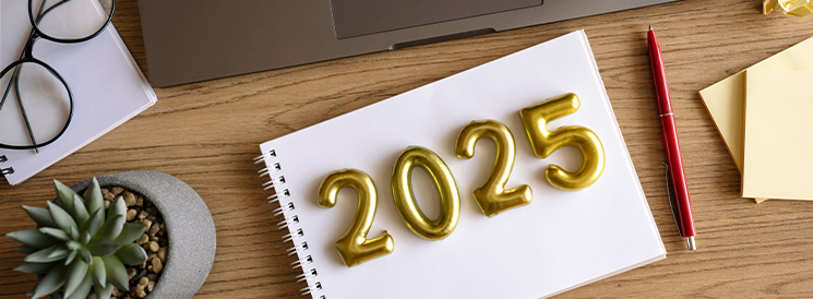 Desk with notebook and 2025 balloons