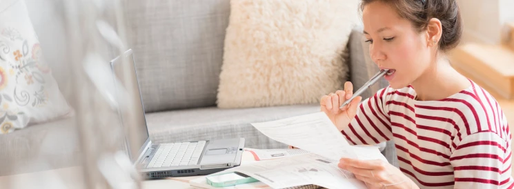 Woman reviewing finances on laptop