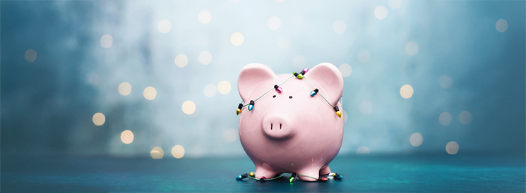 Pink piggy bank with multi-coloured Christmas lights