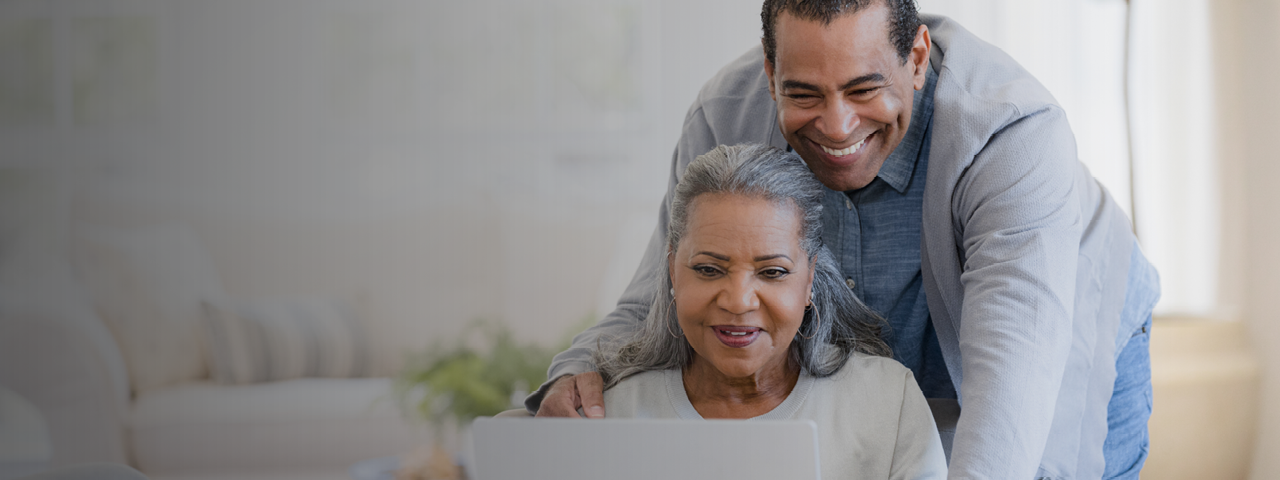 Couple using laptop to claim Collabria Welcome Points Offer