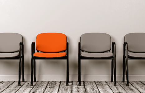 Three grey chairs and one orange chair