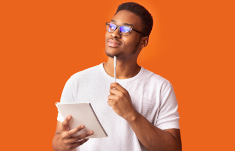 Man with glasses and white shirt holding tablet researching financial literacy tips