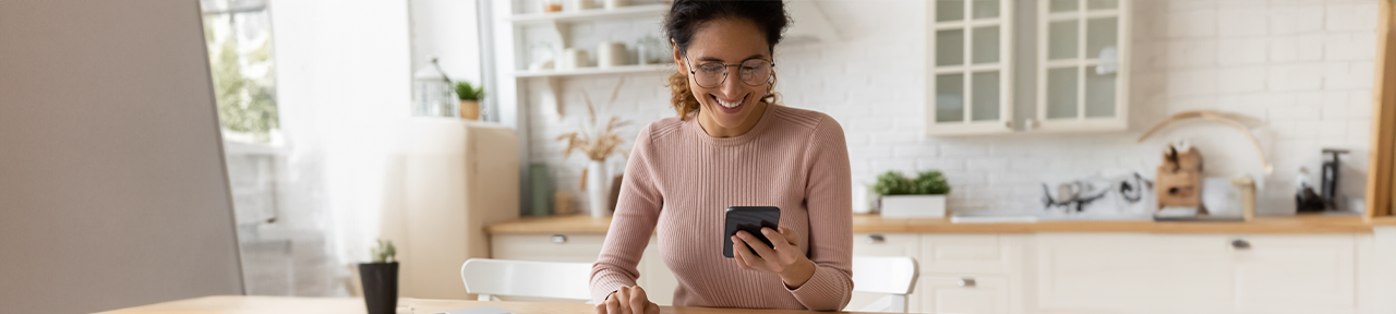 Woman smiling while setting up CardWise on mobile device