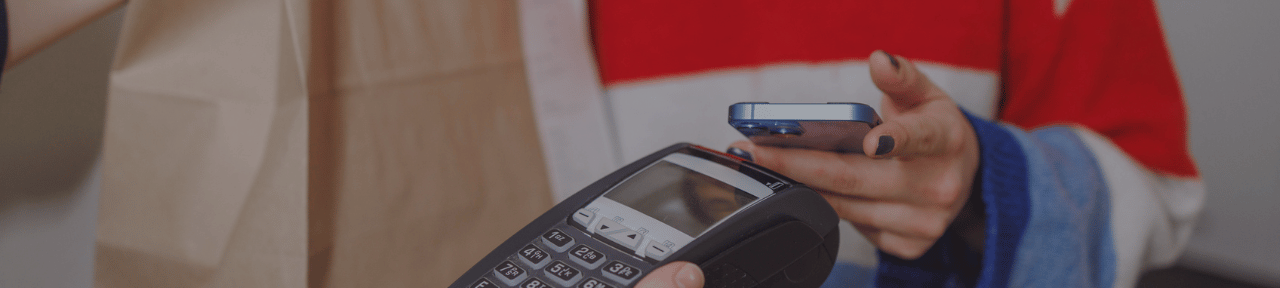 Person using mobile phone to pay with mobile wallet